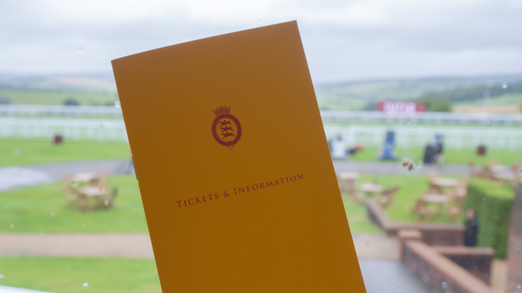 Compass Associates - Qatar Glorious Goodwood Festival 2021 - programme pictured in front of race course